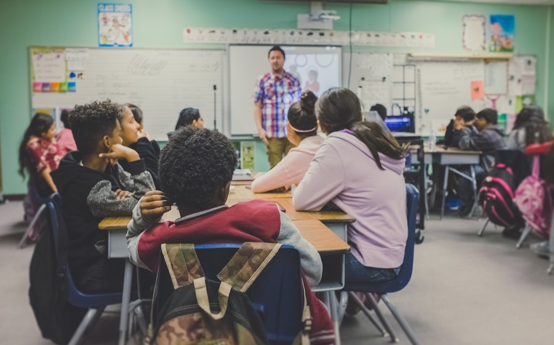 A teacher supporting students in a classroom